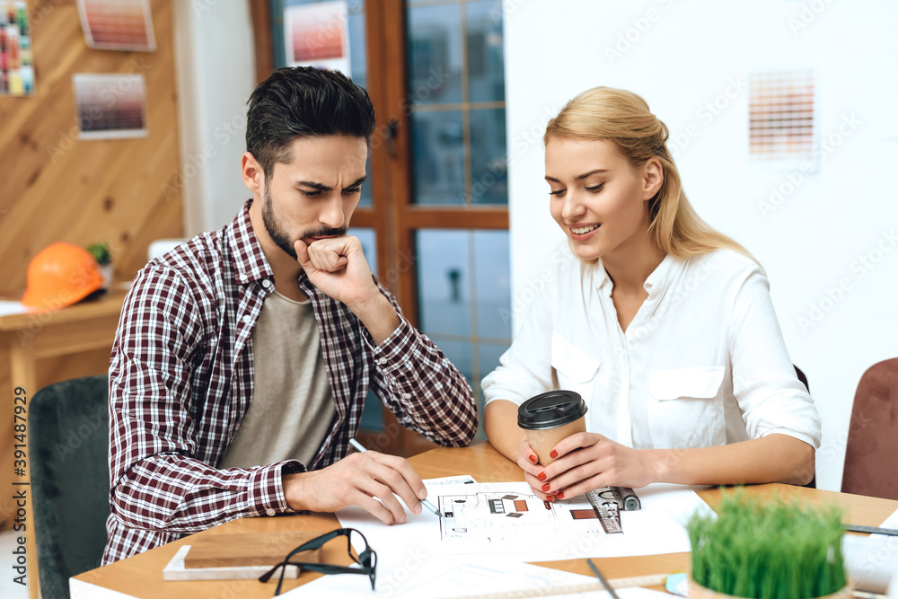 A man sits with a girl at a table and discuss work A man sits with a girl at a table and discuss work