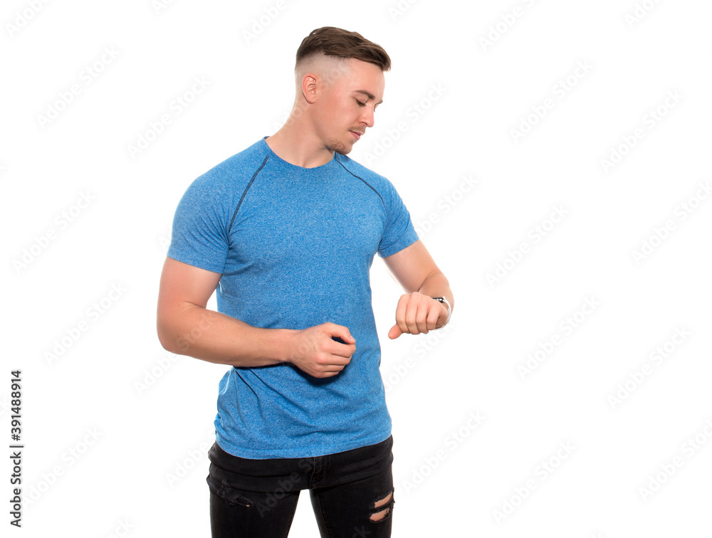 Handsome young and fit man in t-shirt with fitness watch on isolated background Handsome young and fit man in t-shirt with fitness watch on isolated background