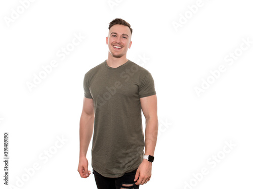 Handsome young and fit man in t-shirt with fitness watch on isolated background