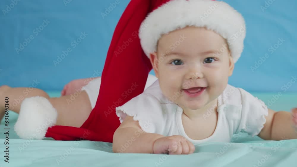 Portrait of adorable infant baby girl wearing Santa hat. Christmas celebration concept. Portrait of adorable infant baby girl wearing Santa hat. Christmas celebration concept.