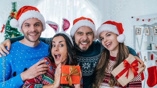 Joyful friends celebrating Christmas at home