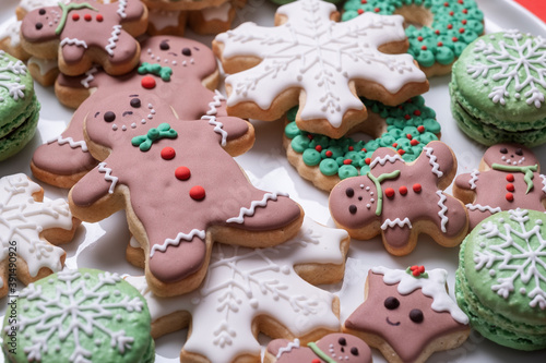 Christmas cookies and gingerbread man with icing on a white plate