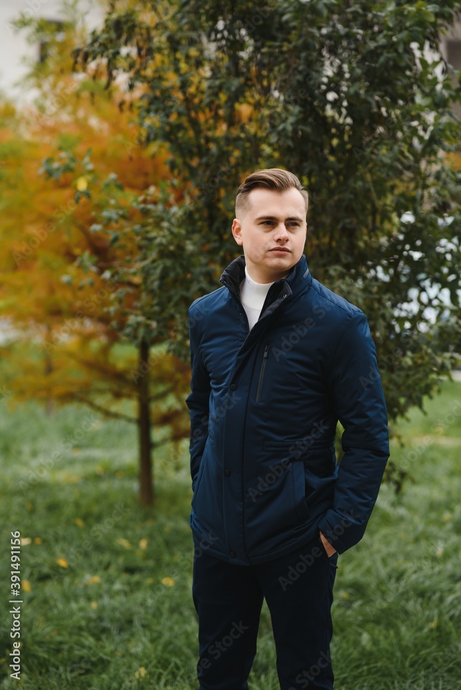 Portrait of a young handsome man, model of fashion, with modern hairstyle in urban background, wearing casual clothes. Portrait of a young handsome man, model of fashion, with modern hairstyle in urban background, wearing casual clothes.