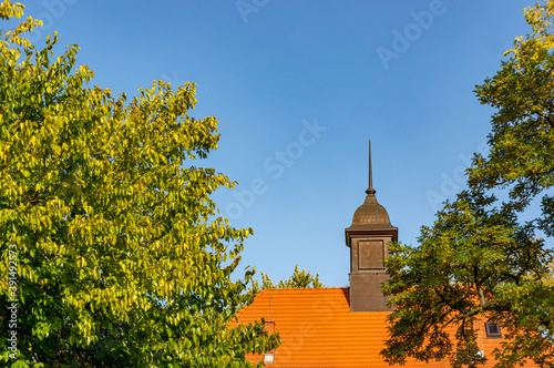 POZNA, POLAND - Oct 25, 2020: Building with tower at a park photo