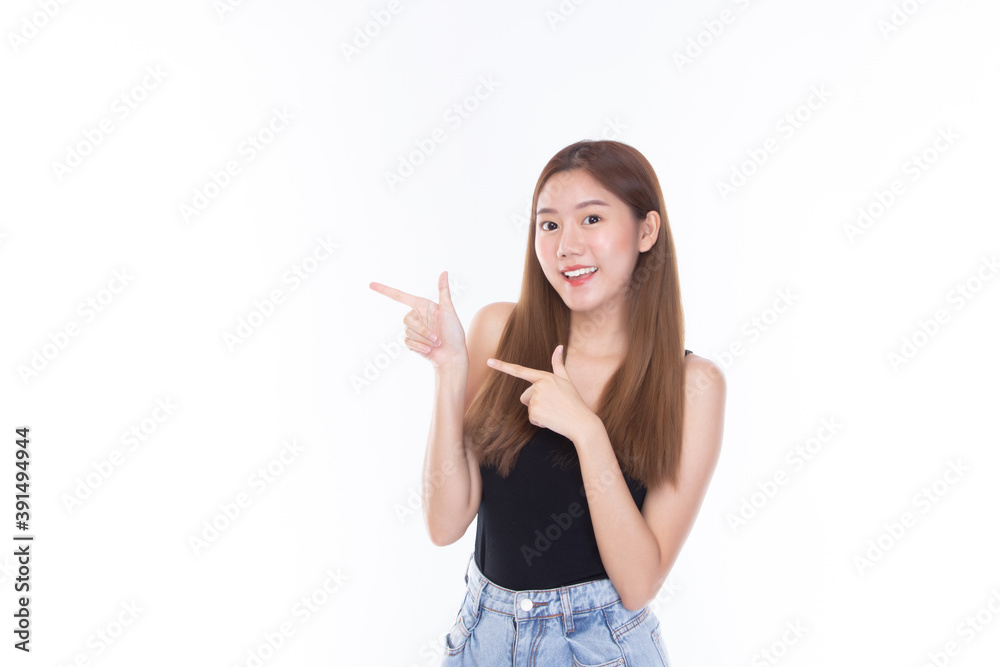 Beautiful woman wearing casual clothes smile and pointing finger at copy space on white wall background studio portrait. Beautiful woman wearing casual clothes smile and pointing finger at copy space on white wall background studio portrait.