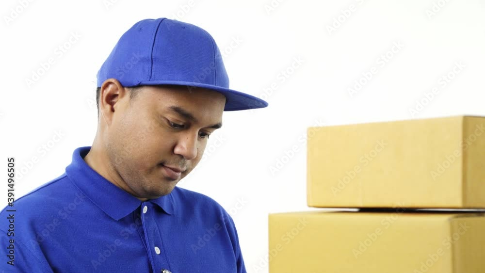 Young asian delivery man in blue uniform checking the parcel stock and note on clipboard for sending to customer. 4k Resolution. Young asian delivery man in blue uniform checking the parcel stock and note on clipboard for sending to customer. 4k Resolution.