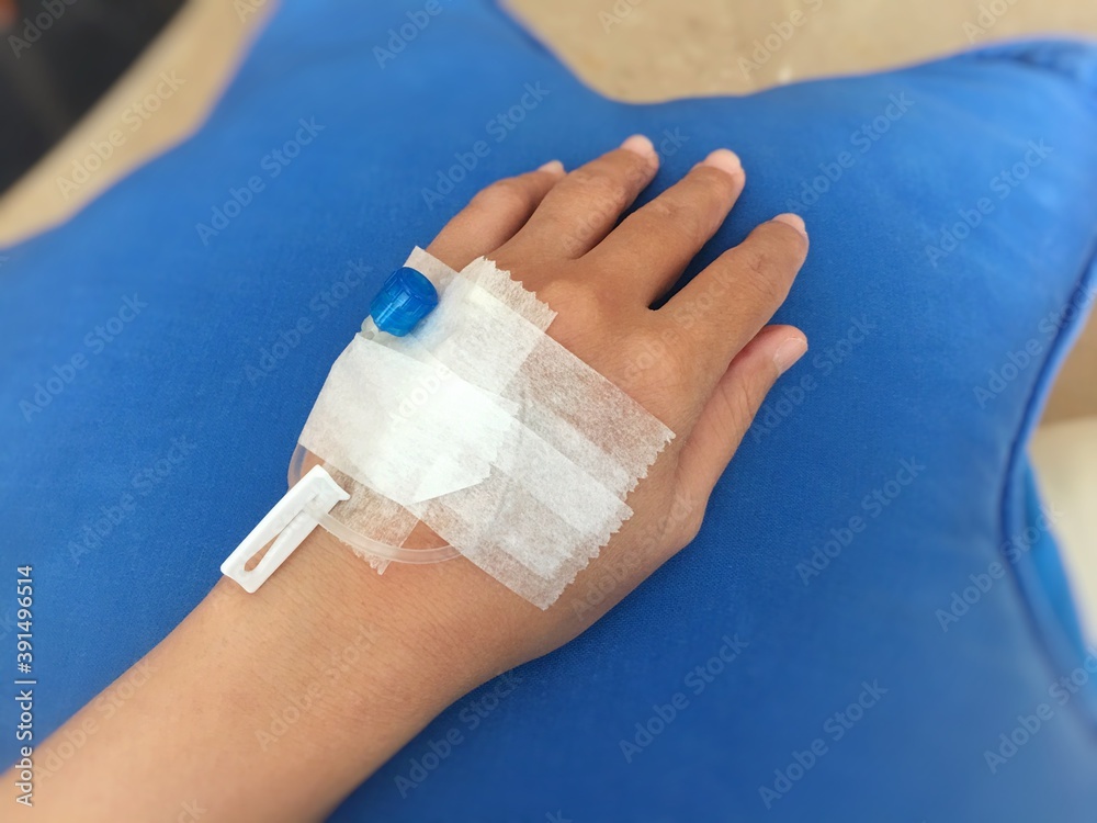 Left hand with injection needle.
