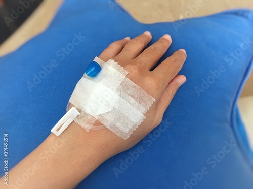 Left hand with injection needle.