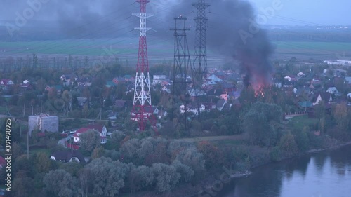 burning house, dangerous fire near electric power lines