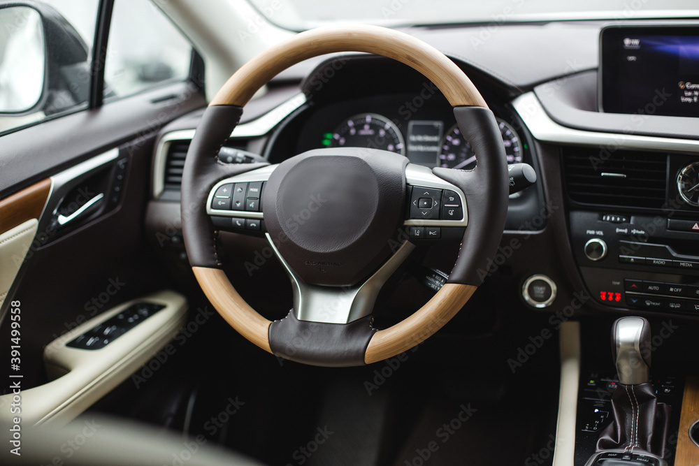 Interior view of car, luxury car steering wheel and dashboard with display or monitor screen.