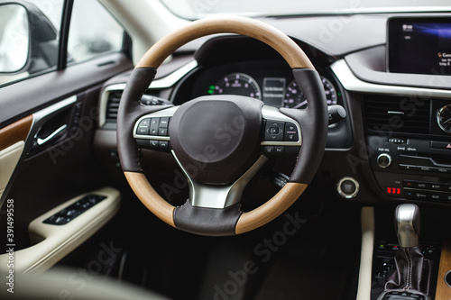 Interior view of car, luxury car steering wheel and dashboard with display or monitor screen. © Hanna