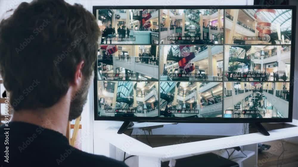 People Surveillance On Mall Security Cameras CCTV System. Man watching