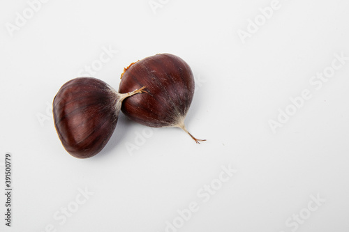 Many chestnuts, close up. White blackground.
