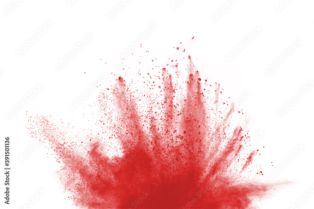 Freeze motion of red color powder exploding on white background. 