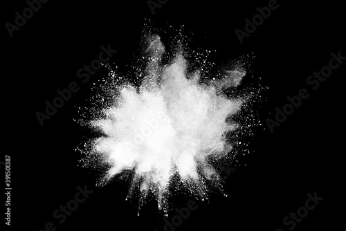 White powder or flour explosion isolated on black background.