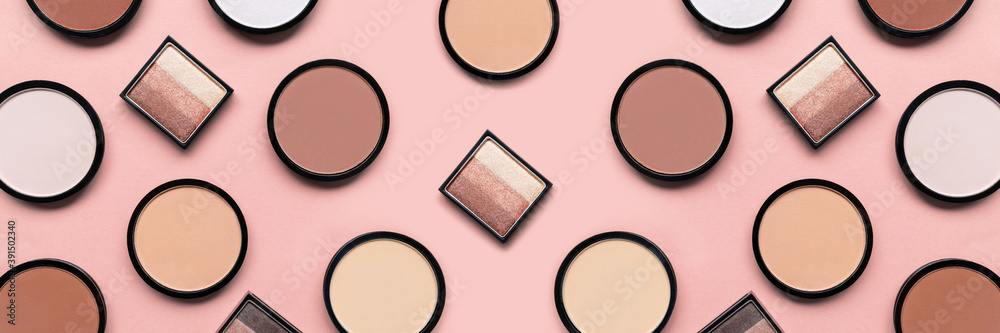 Cosmetic products on pastel pink background. Beige eyeshadow, blush and mineral compact face powder for different skin colors concept. Beauty banner. Trendy colors. Makeup accessories. Tone foundation Cosmetic products on pastel pink background. Beige eyeshadow, blush and mineral compact face powder for different skin colors concept. Beauty banner. Trendy colors. Makeup accessories. Tone foundation