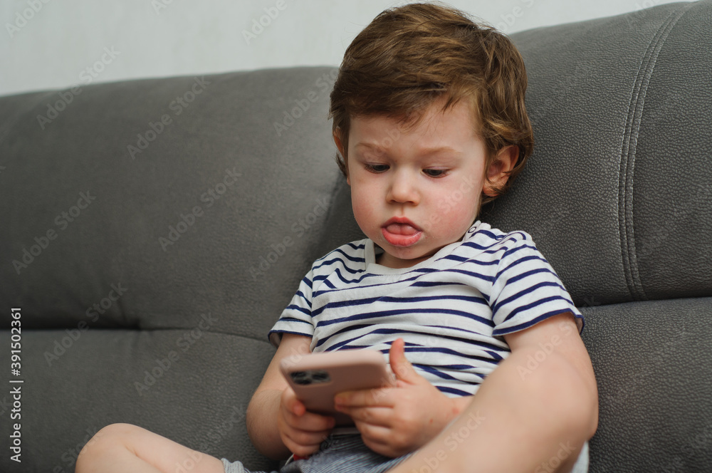 Cute little boy looking at camera, funny child at home Cute little boy looking at camera, funny child at home