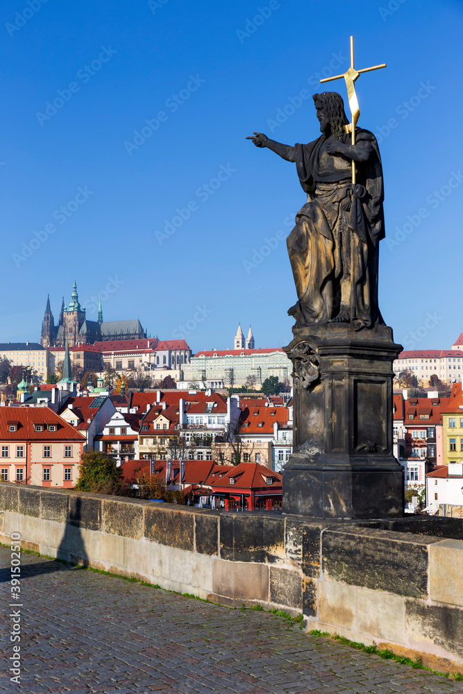Autumn colorful Prague Lesser Town with gothic Castle from Charles Bridge with its baroque Sculpture, Czech Republic