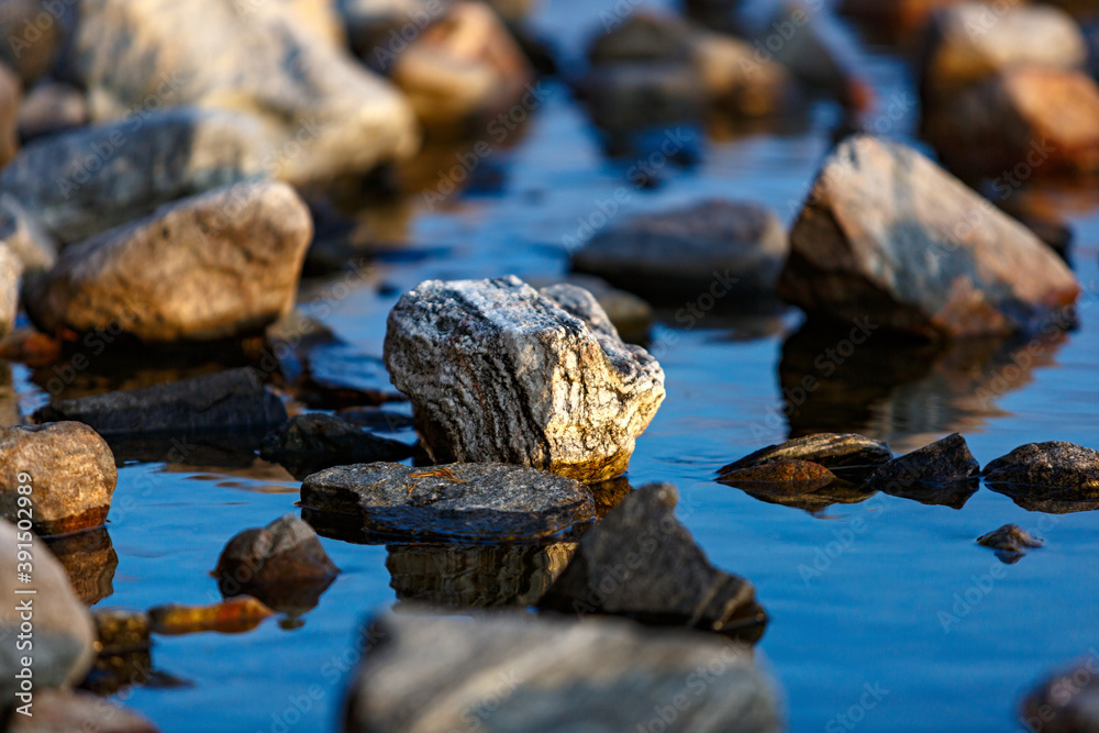 Stones in the water of Lake Imandra. Autumn landscape, Kola Peninsula, Russia. Stones in the water of Lake Imandra. Autumn landscape, Kola Peninsula, Russia.