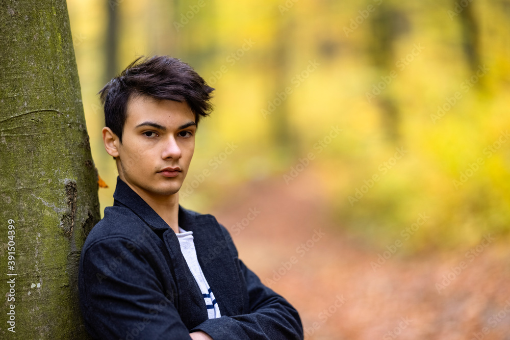 Portrait with a handsome young man in autumn forest, fashion concept. Portrait with a handsome young man in autumn forest, fashion concept.