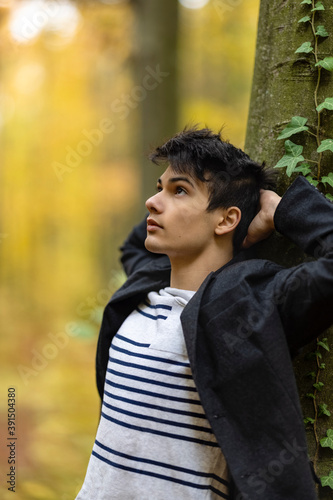 Portrait with a handsome young man in autumn forest, fashion concept.