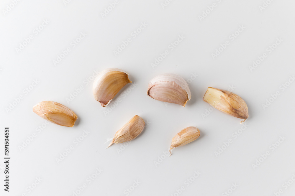 Pieces of raw garlic on isolated white background. Top view Garlic bulbs.