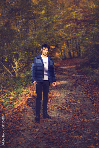 Portrait with a handsome young man in autumn forest, fashion concept.