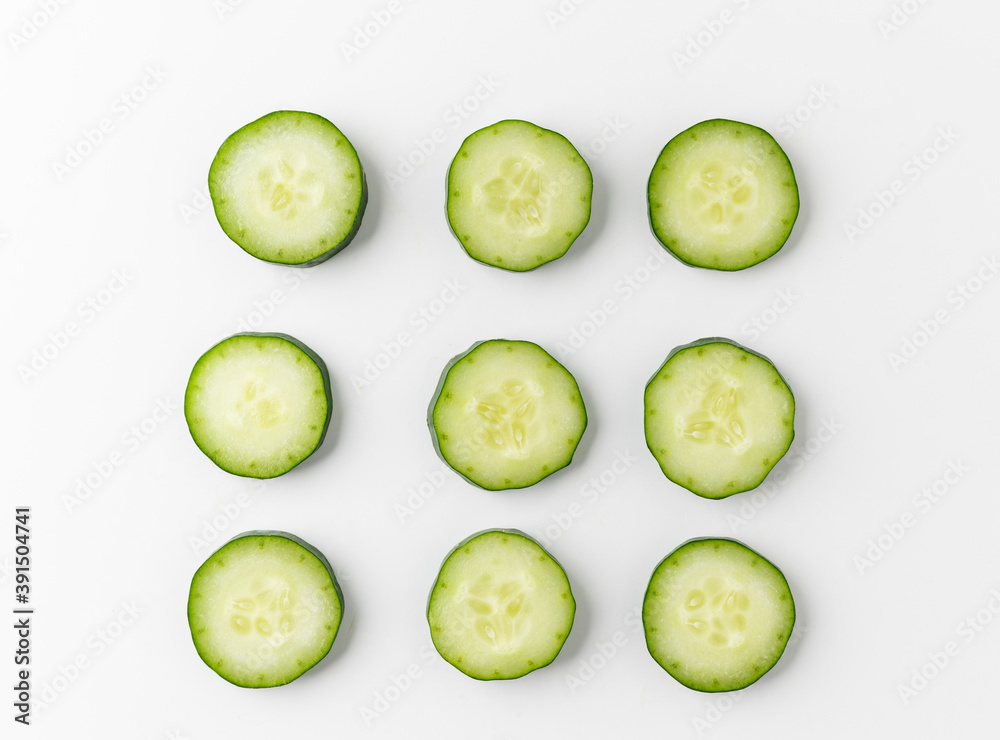 Pile Cucumber sliced into circle and arranging on white table isolated background. Healthy vegetables and food. Pile Cucumber sliced into circle and arranging on white table isolated background. Healthy vegetables and food.