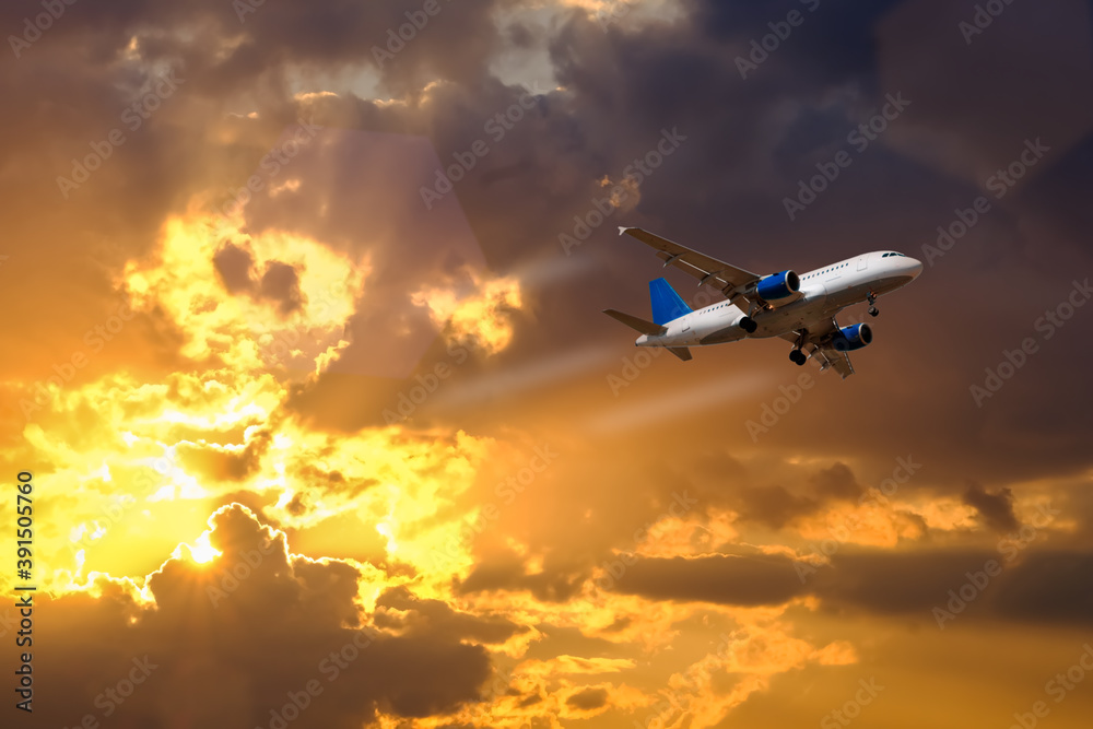 airplane fly over dramatic sunset