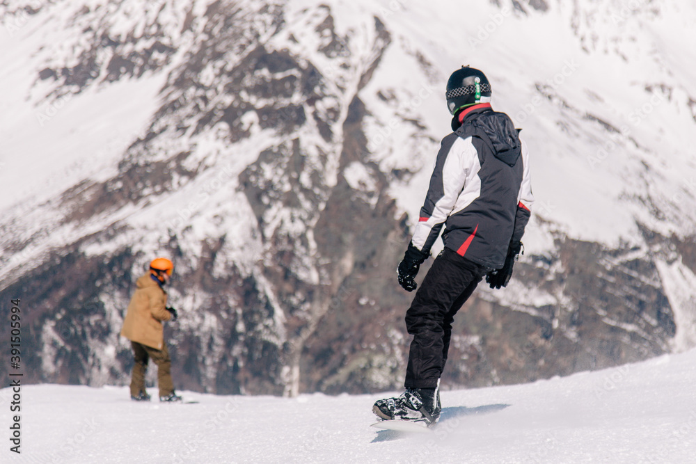 People ski and snowboard at a beautiful resort in the mountains of Georgia