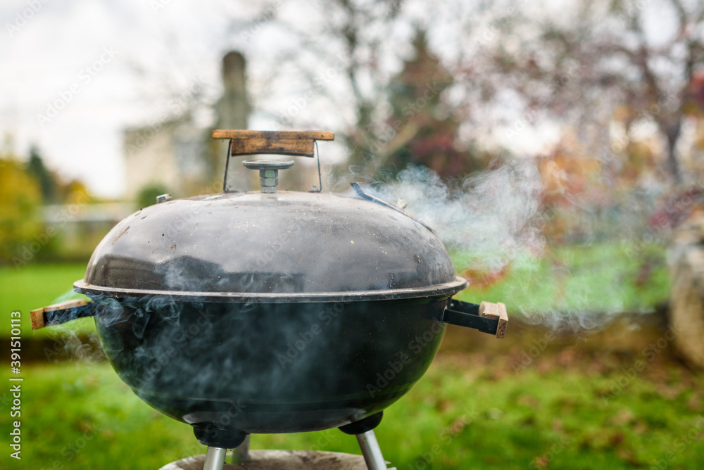 Kettle Charcoal BBQ Barbecue Grill in garden or backyard. Kettle Charcoal BBQ Barbecue Grill in garden or backyard.