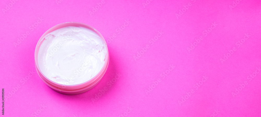 Beauty cream jar on pink background