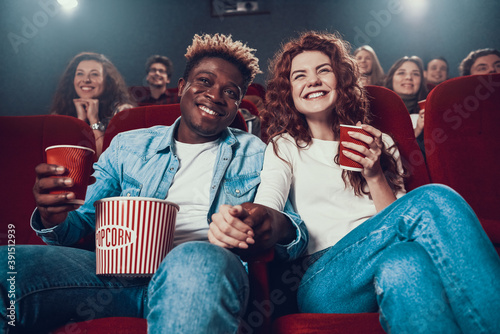 Couple in love watching movie in movie theater.