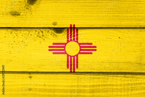 new mexico flag painted on old wood plank background. Brushed natural light knotted wooden board texture. Wooden texture background flag of new mexico
