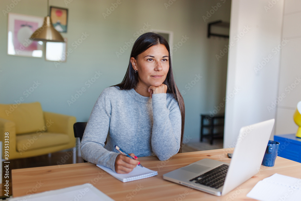 Pensive woman thinking what to write at home. Pensive woman thinking what to write at home.