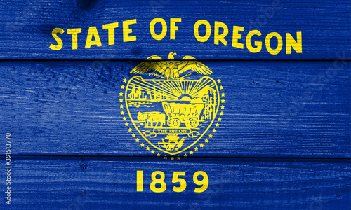 oregon flag painted on old wood plank background. Brushed natural light knotted wooden board texture. Wooden texture background flag of oregon