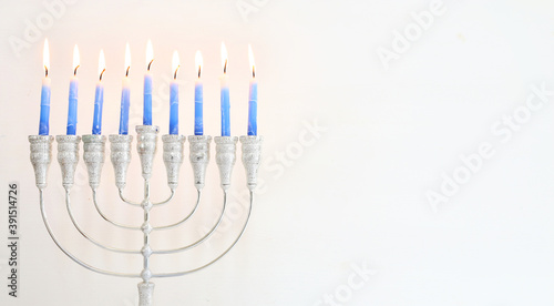 Religion image of jewish holiday Hanukkah background with menorah  traditional candelabra  and candles