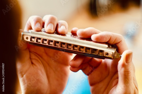 hand holding a harmonica photo