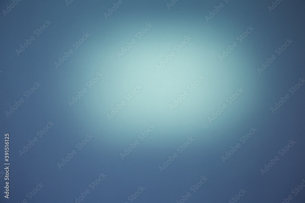 Light spot of light on a semi-blurred dark blue background Light spot of light on a semi-blurred dark blue background