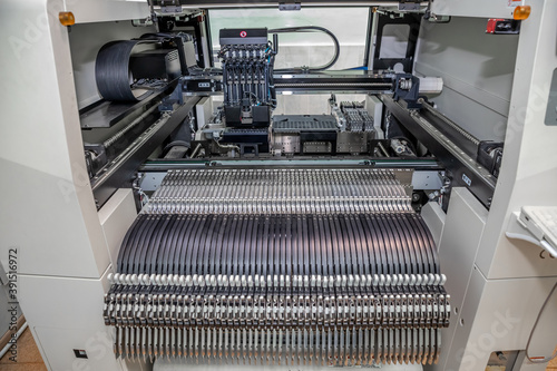 chip mounter. Automatic machine for the Assembly of chips on an electric circuit Board photo