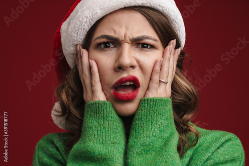 Attractive young woman wearing santa hat isolated