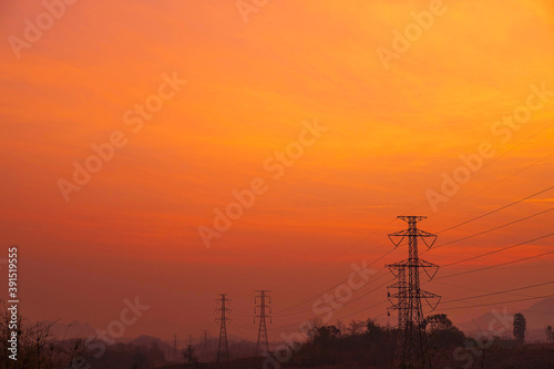 Electricity poles and landscape in the evening at sunset
