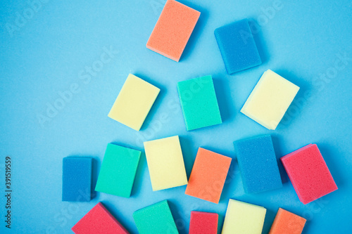 New colorful sponges for washing dishes on blue background