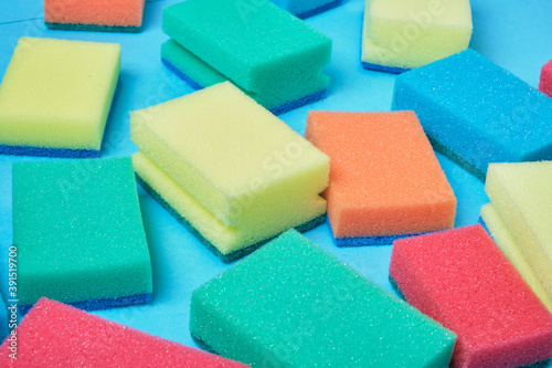 New colorful sponges for washing dishes on blue background