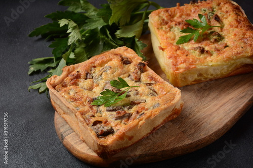 Homemade quiche or pie with broccoli, seasonings, champignons and cheese on a gray background.