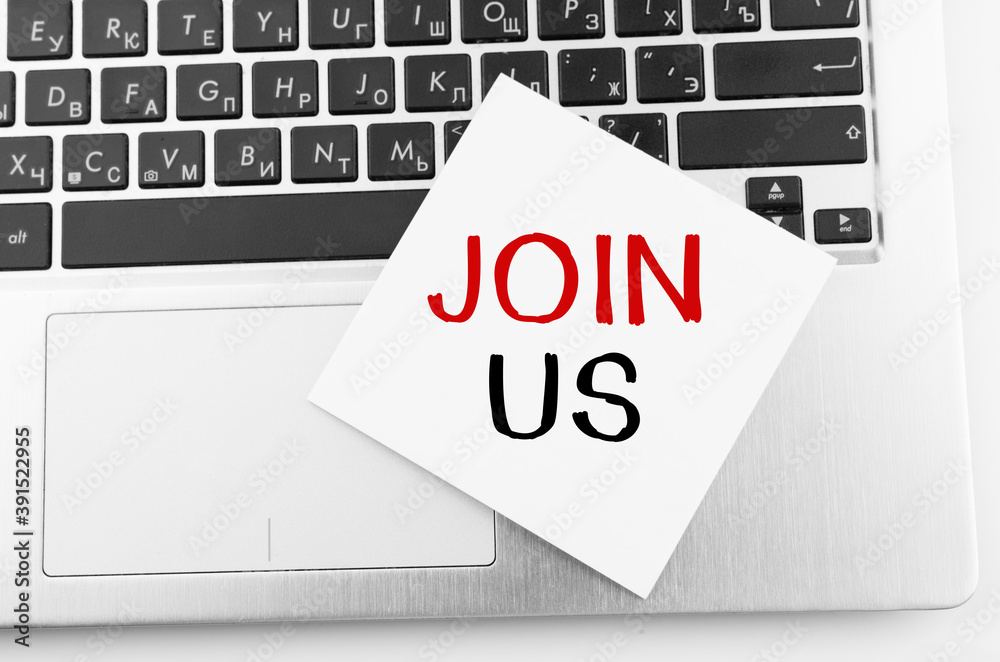 Laptop with memo sticks on the keyboard with text JOIN US on it. Laptop with memo sticks on the keyboard with text JOIN US on it.