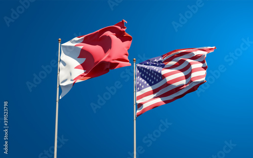 Beautiful national state flags of USA and Bahrain together at the sky background. 3D artwork concept.