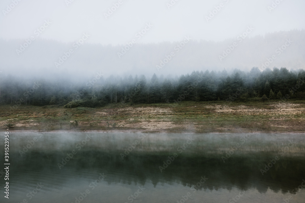 Foggy early morning on the mountain lake
