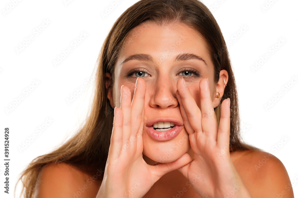 Young beautiful woman whispers Young beautiful woman whispers