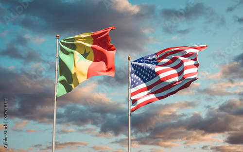 Beautiful national state flags of Senegal and USA together at the sky background. 3D artwork concept.